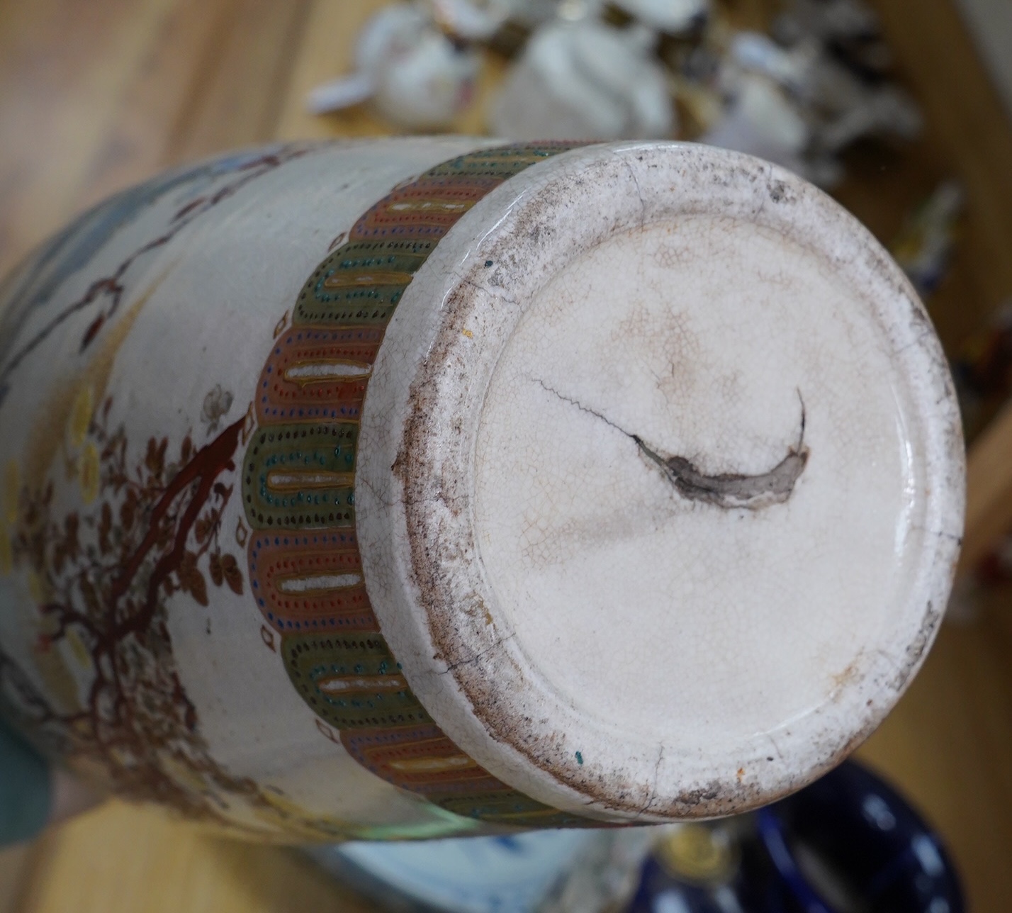 A pair of Japanese Satsuma vases on stands, a pair of floral enamel vases and another Satsuma pottery vase, largest 35cm high. Condition - poor